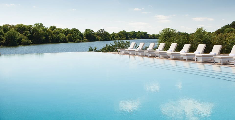 The natural setting and the luxurious amenities like the outdoor pool promote a sense of serenity.