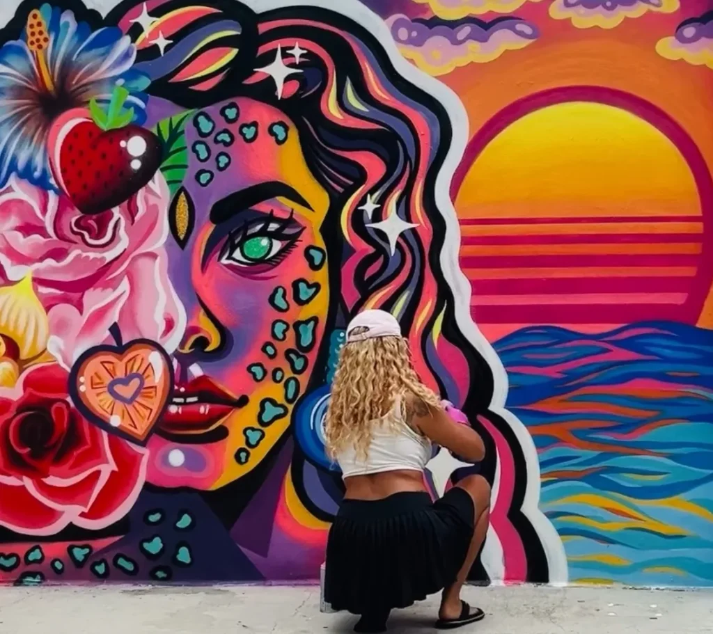 An artist paints a mural.